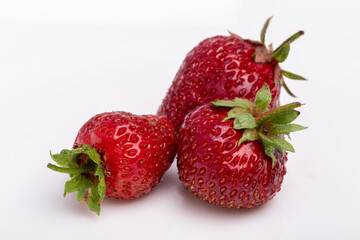 three strawberries on white