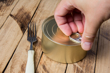 Tin can for food on wooden background. Packaging, product. Storage of food for a long time.