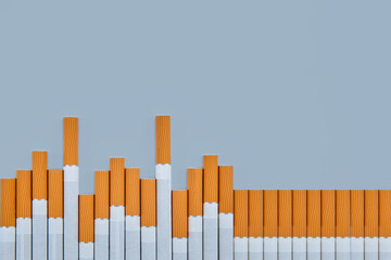 the layout on which the cigarettes are located is made in the form of a cardiogram of the heart. the concept of Smoking harm