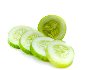 slices of fresh green cucumber. isolated white background. copyspace