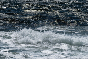 Huge waves crashing in over the norwegian shorline, leaving a salty mist in the air