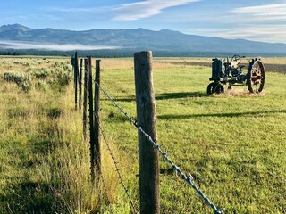 Idaho farm, barbed wire fence in an open field 