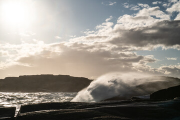 Fototapeta premium Beautiful landscape of the ocean as big waves come crashing in over the rocky shore