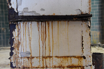 Metal plank leaking rust over old paint. 