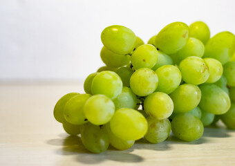 Bunch of Green Seedless Grape solated on white background.