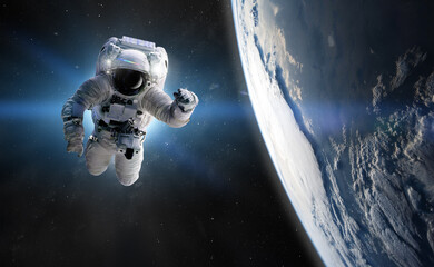 Astronaut at spacewalk. Concept of conquering the universe by the human race. Elements of this...