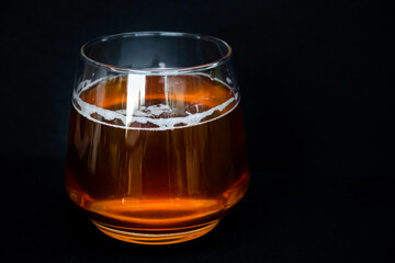 Glass of delicious beer. Light alcohol drink. Dark background. 