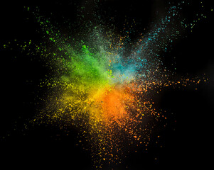 Colored powder explosion on black background. Freeze motion.