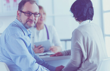 Fototapeta premium American doctor talking to woman in surgery