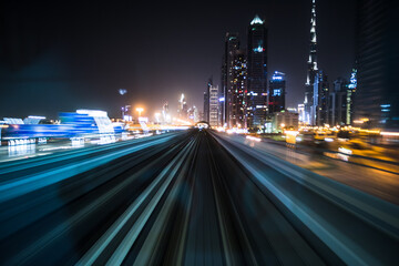 Tran running on rails in a night city., blurred motion with light.