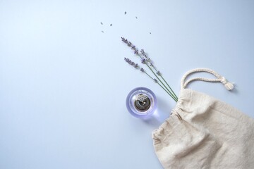 Composition with natural lavender cosmetics product and flowers in eco bag. Natural organic cosmetic concept.Lavender water.