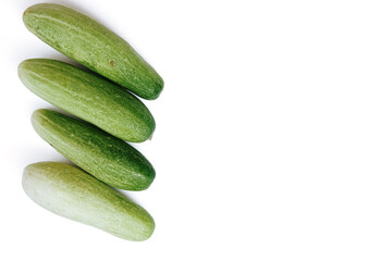 fresh green cucumbers with a background isolated white background with copyspace