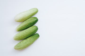 fresh green cucumbers with a background isolated white background with copyspace