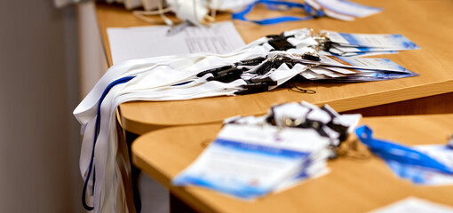 business conference. A stack of badges lies on the edge of the table for the participants' staff