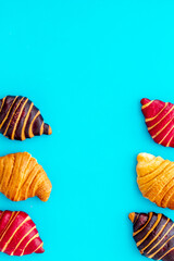 Frame of croissants - fresh bakery on blue background. Top view
