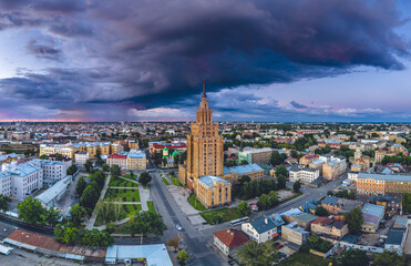 Obraz premium Aerial view of iconic Riga city in dramatic sunset. Modern architecture in Europe with storm clouds