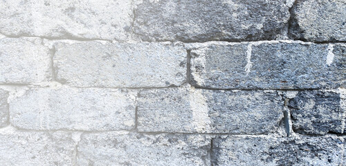 Old rustic gray brick wall panorama. Masonry gray texture or background. Copy space for text or description.