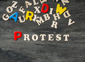 wooden letters with protest word