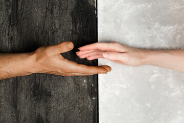 multi racial hand shake on black and white background. Stop racism concept