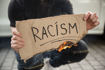 Young man burned racism text on paper