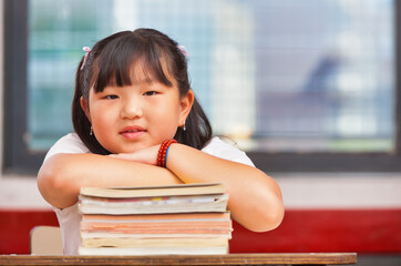 Elementary school scene. Asian schoolgirl in the classroom