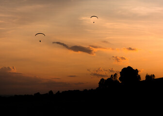 paraglider silhouette at sunset