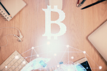 Double exposure of blockchain theme hologram over table with phone. Top view. Crypto technology...