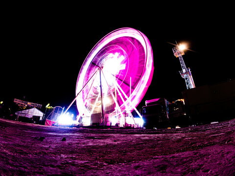 A Ferris wheel long exposure, colorful motion blur.A Ferris wheel long exposure, colorful motion blur.