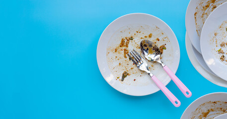 Dirty dishes on blue background.