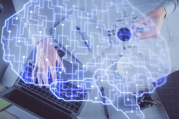 Double exposure of man's hands typing over computer keyboard and brain hologram drawing. Top view. Ai and data technology concept.