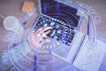 Multi exposure of man's hands typing over computer keyboard and data theme hologram drawing. Top view. Technology concept.