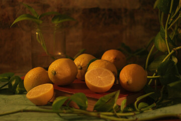 many healthy and natural juicy lemons on the table next to a jar with a plant and a potus...