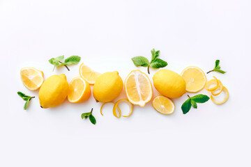 Fresh lemons and mint leaves on white background. Top view
