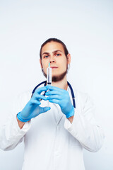 young pretty doctor with stethoscope holding syringe wearing gloves isolated on white background