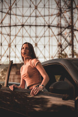 Beautiful girl poses with sexy look out of her car