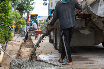 Mixed concrete pouring at construction site. Pouring cement during sidewalk upgrade. Pour concrete,Pouring ready-mixed concrete after placing steel reinforcement on street