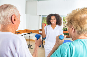 Elderly people at the gym making physical exercises