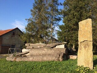 Wooden beams with a high stone in the courtyard of a small village