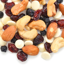 Mix nuts, dry fruits and chocolate on a white background