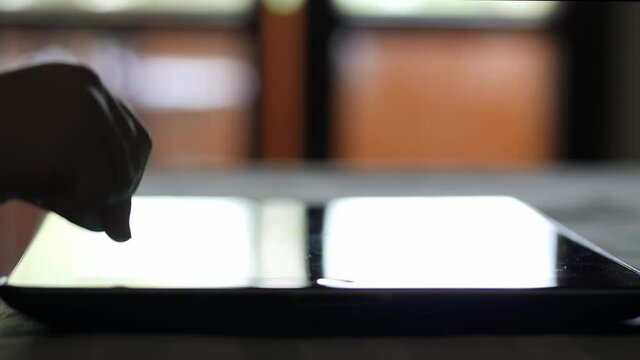 Hand of a child who presses persistently and frenzy on a tablet screen. Growth disorder concept in the use of electronic devices.