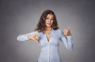 Thumb up or down. Skeptical thinking woman judging deciding
