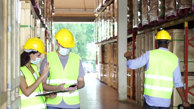 Diversity workers wear face mask as new normal greeting in warehouse