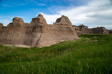 The Notch, Door and Window area of Badlands National Park, with green grass in foreground. South...