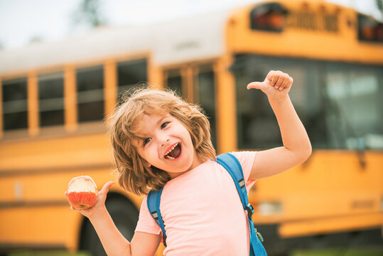 Happy school kids on school bus. Child thumbs up smiling and happy.