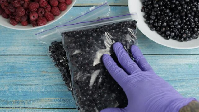 Packages with blueberries in zipper plastic bags for freezing. Frozen, preservation berries food