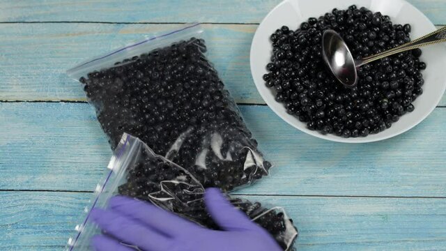 Packages with blueberries in zipper plastic bags for freezing. Frozen, preservation berries food