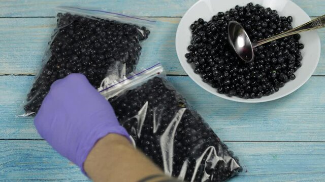Packages with blueberries in zipper plastic bags for freezing. Frozen, preservation berries food