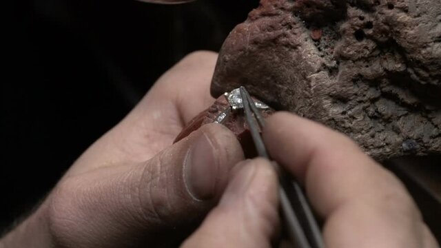 craftsman making diamond ring. hand made jewelery. Put diamond gem ring. diamond ring production. Solitaire diamond ring making.