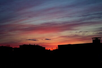Silhouette of buildings with pinkish red twilight sky in the background captured in Kiruna, Sweden