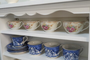 Fototapeta na wymiar Teacup collection on white rack